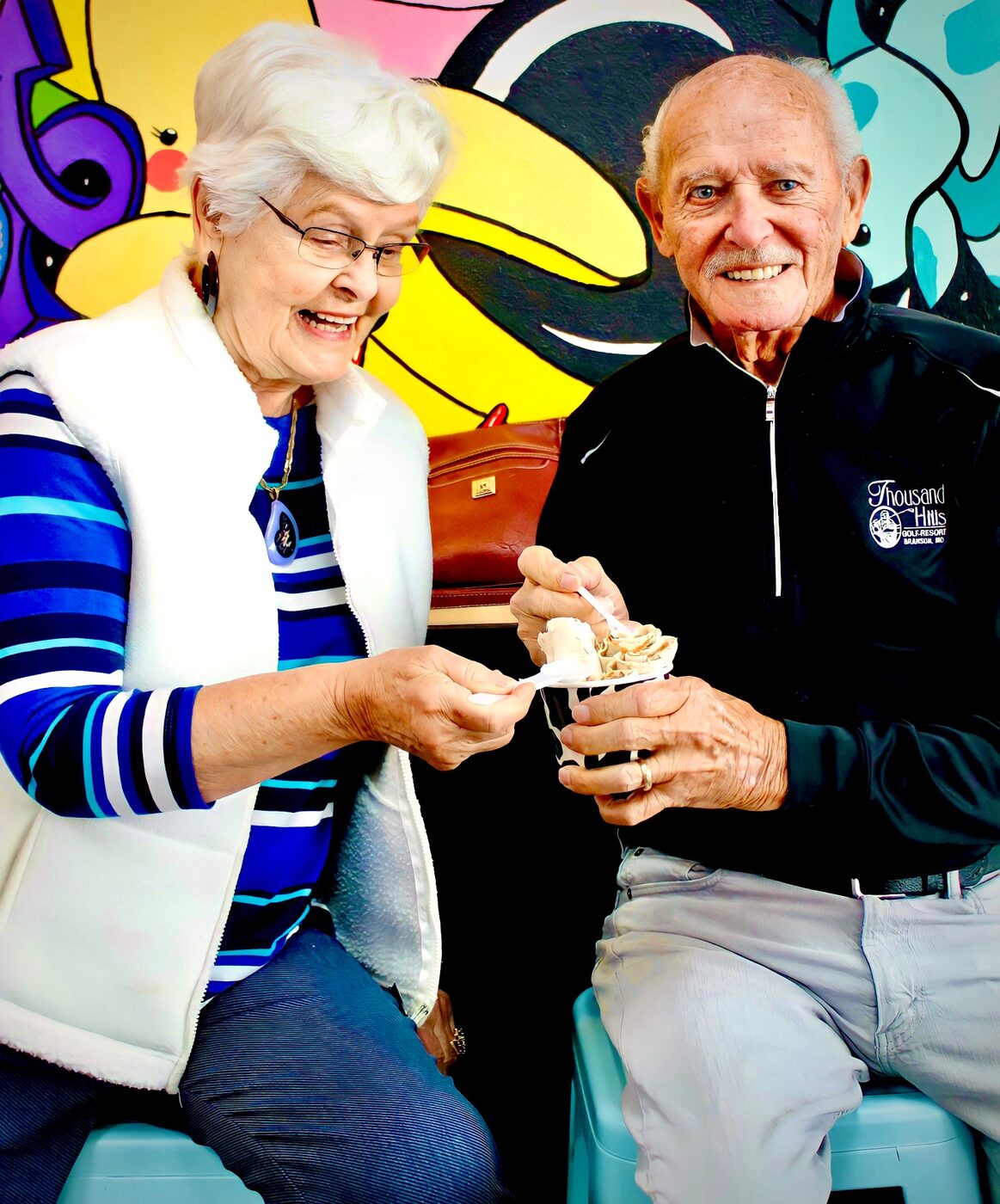 Smiling customers sharing a cup of YOLO rolled ice cream